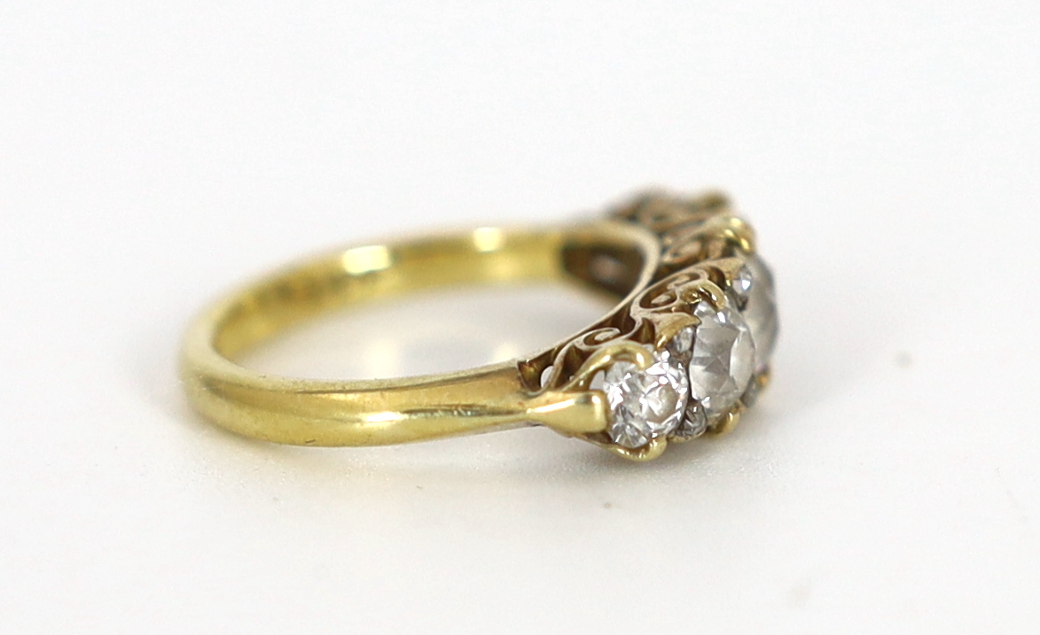 An early 20th century 18ct gold and graduated old round cut diamond set half hoop ring